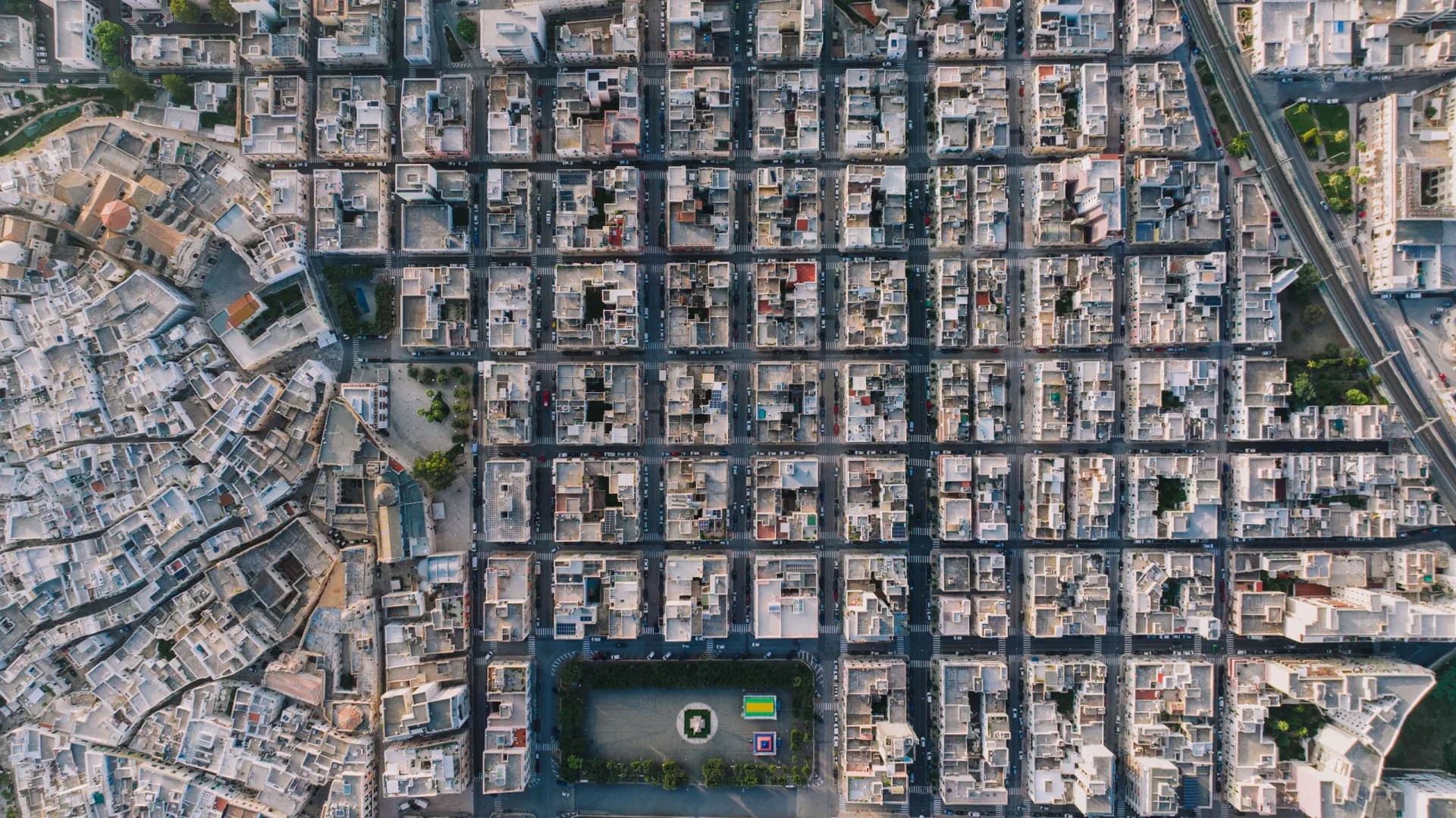 Aerial view looking straight down on a town laid out as a regular grid of streets and rectangular blocks.